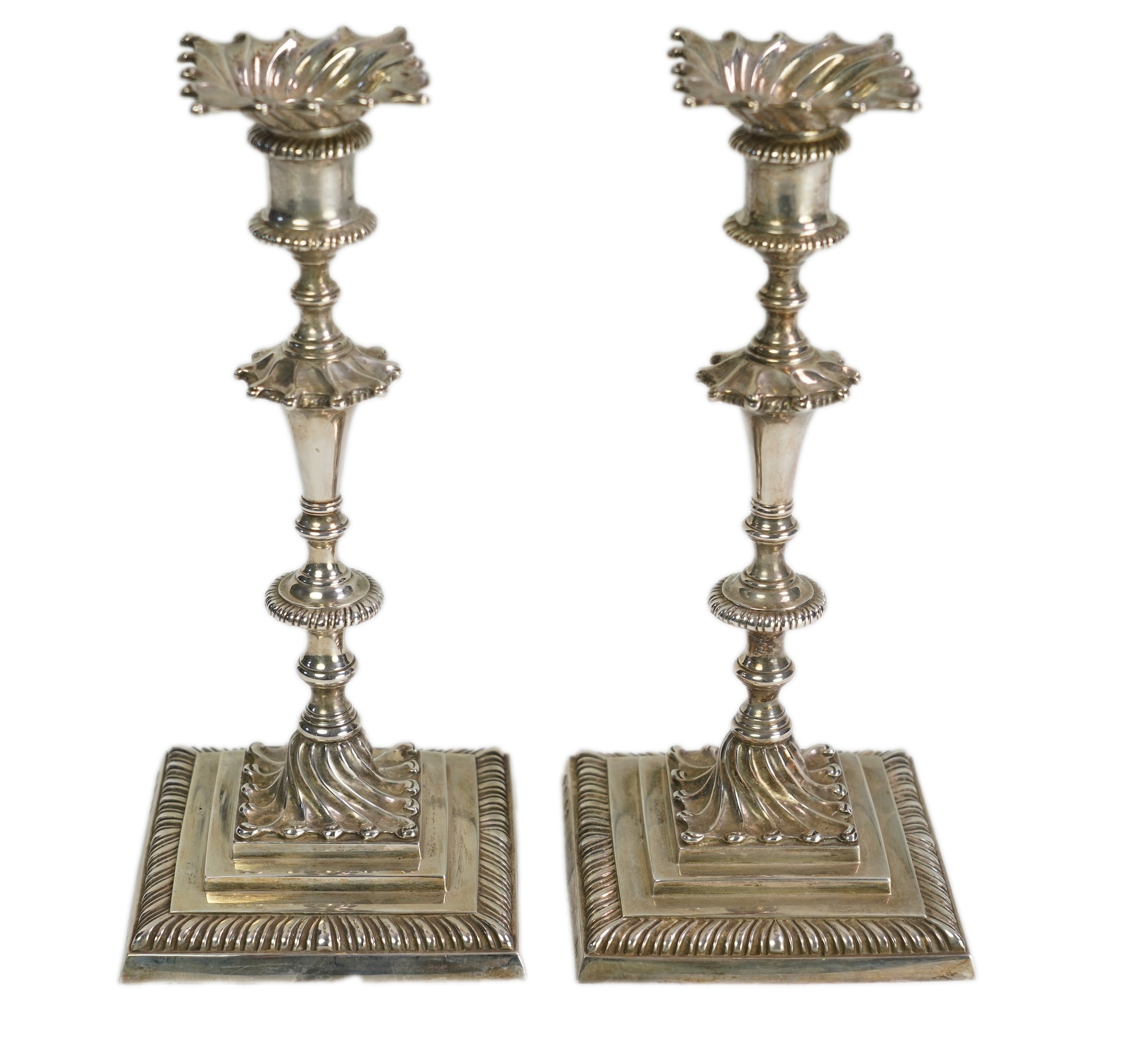 A pair of Elizabeth II 18th century style Asprey & Co cast silver candlesticks